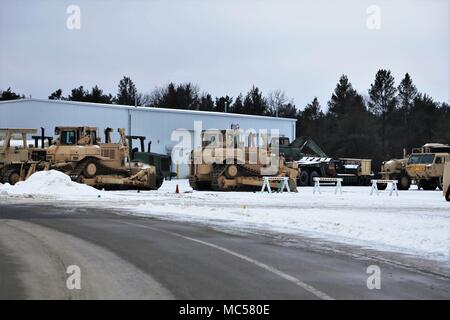 Army military vehicles are parked at a staging area Jan. 24, 2018, on the cantonment area at Fort McCoy, Wis. The vehicles were staged prior to being weighed and shipped by rail from the installation. (U.S. Army Photo by Scott T. Sturkol, Public Affairs Office, Fort McCoy, Wis.) Stock Photo