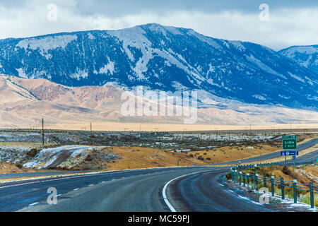 Driving in Snow and Ice on scenic highway Interstate 15 in southwesten Montana in late October, with the snow-covered Pioneer mountains in the distanc Stock Photo