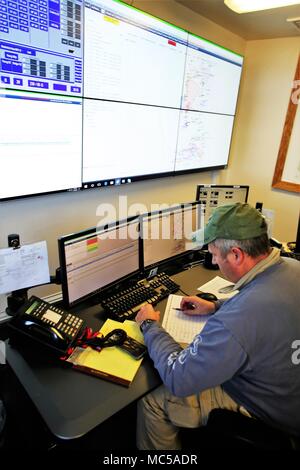 Range Control Technician Mark Confer with the Directorate of Plans, Training, Mobilization and Security works at the Fire Desk on Jan. 16, 2018, at Fort McCoy, Wis. The desk operates communications with units using the range complex as well as Range Maintenance and other personnel throughout 46,000 acres of training areas on Fort McCoy. (U.S. Army Photo by Scott T. Sturkol, Public Affairs Office, Fort McCoy, Wis.) Stock Photo