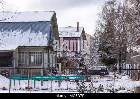 Spring on the street suburban village. At night, snow fell and begins to melt in the morning. Stock Photo