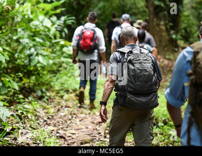 Members of the 346th Air Expeditionary Group hike along a trail in the Darien National Park, Panama, April 2, 2018, during exercise New Horizons 2018. At the end of the hike, the exercise participants spoke with rural village members about the benefits that New Horizons 2018 would bring to their community, including medical assistance and facilities such as schools, a youth community center and a women’s health ward. Exercise New Horizons is a joint training exercise where all branches of the U.S. military conduct training in civil engineer, medical and support services while benefiting the lo Stock Photo