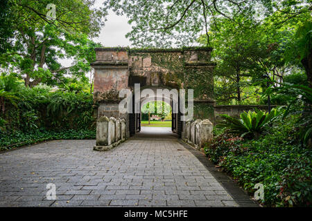 The facade entrance of the Fort Gate surrounded by forest at Fort Canning Park, Singapore in the daytime. Stock Photo