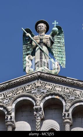 Close up of the statue of St Michele of the 13th century Romanesque facade of the San Michele in Foro, Lucca, Tuscany, Italy, Italy, Italian. Stock Photo