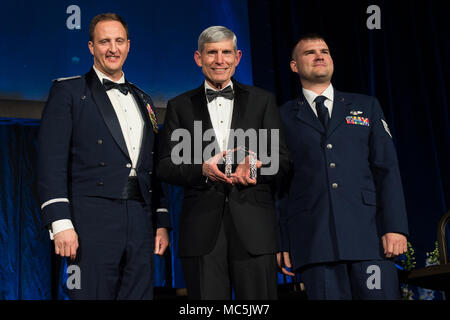 Retired U.S. Air Force Gen. Norton A. Schwartz, center, President and Chief Executive Officer of Business Executives for National Security (BENS); recognizes U.S. Air Force Col. Julian Cheater, left, Commander of the 432d Wing and Air Expeditionary Wing at Creech Air Force Base, Neveda; and U.S. Air Force Tech Sgt. Gavin McClain, right, a sensor operator with the 432d Wing; during the BENS 2018 Eisenhower Dinner in Washington, D.C., April 5, 2018. The theme of the evening focused on the importance of innovation, transformation, and leadership in strengthening national security. (DoD Photo by U Stock Photo