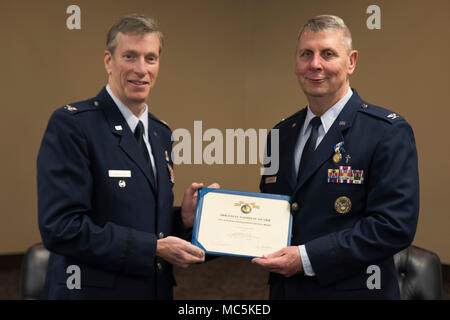 Retired Col. Mark W. Anderson, Former Commander 188th Wing, presents Col. Thomas Smith, Joint Force Headquarters Command Chaplain, with the Arkansas Distinguish Service Medal at Fort Smith, AR., Apr. 07, 2018. (U.S. Air National Guard photo by Tech. Sgt. Daniel Condit) Stock Photo