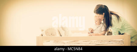 Mother using digital tablet with baby boy Stock Photo