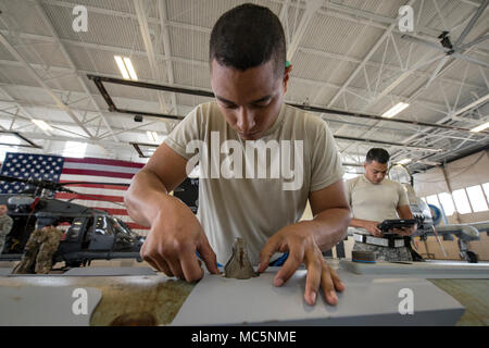 Senior Airman Luis Bautista-Mercedes, 74th Aircraft Maintenance Unit (AMU) weapons load crew member, checks an umbilical on an MK-84 general purpose bomb during a weapons-load competition, April 6, 2018, at Moody Air Force Base, Ga. During the load portion of the competition Airmen from the 74th and 75th AMU were assessed on their ability to quickly and efficiently load munitions onto an A-10. They were also judged on dress and appearance and a written test based on munitions knowledge. (U.S. Air Force photo by Airman Eugene Oliver) Stock Photo