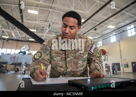 Staff Sgt. Isiah McNeal 723d Aircraft Maintenance Squadron weapons load crew chief, writes notes during a weapons-load competition, April 6, 2018, at Moody Air Force Base, Ga. During the load portion of the competition Airmen from the 74th and 75th Aircraft Maintenance Unit as well as the 723d AMXS were assessed on their ability to quickly and efficiently load munitions onto an A-10C Thunderbolt II and HH-60. They were also judged on dress and appearance and a written test based on munitions knowledge. (U.S. Air Force photo by Airman Eugene Oliver) Stock Photo