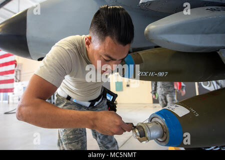 Staff Sgt. Jorge Galvez, 74th Aircraft Maintenance Unit (AMU) weapons load crew team chief, checks the umbilical on an inert MK-84 general purpose bomb during a weapons-load competition, April 6, 2018, at Moody Air Force Base, Ga. During the load portion of the competition Airmen from the 74th and 75th AMU were assessed on their ability to quickly and efficiently load munitions onto an A-10. They were also judged on dress and appearance and a written test based on munitions knowledge. (U.S. Air Force photo by Airman Eugene Oliver) Stock Photo