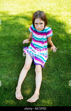 Outdoors portrait of small girl with offended look. Stock Photo