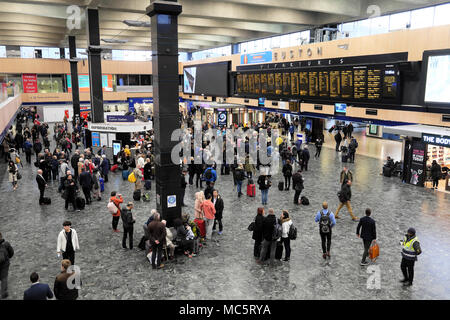 People standing waiting on the concourse looking at the departure board at Euston Station in London England UK    KATHY DEWITT Stock Photo