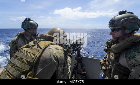 A Sailor assigned to Coastal Riverine Squadron (CRS) 4, Det. Guam fires an M2 machine gun aboard a Mark VI patrol boat during a crew-served weapons qualification in the Philippine Sea, April 12, 2018. CRS-4, Det. Guam, assigned to Costal Riverine Group 1, Det. Guam, is capable of conducting maritime security operations across the full spectrum of naval, joint and combined operations. Further, it provides additional capabilities of port security, embarked security, and theater security cooperation around the U.S. 7th Fleet area of operations. (U.S. Navy Combat Camera photo by Mass Communication Stock Photo