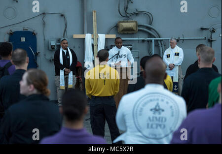 ATLANTIC OCEAN (April 1, 2018) Lt. Alexander Lloyd, a Navy chaplain, preaches the sermon for Easter sunrise service aboard the aircraft carrier USS George H.W. Bush (CVN 77). The ship is underway conducting sustainment exercises to maintain carrier readiness. ( Stock Photo