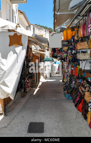 Parga, Epirus Prefecture - Greece. Narrow alley in the town of Parga with gift shops, souvenirs, clothing Stock Photo
