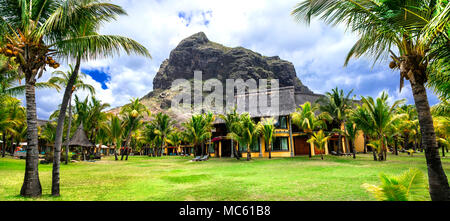 Tropical holidays in Le Morne,view with bungalow,palm trees and mountain,Mauritius. Stock Photo
