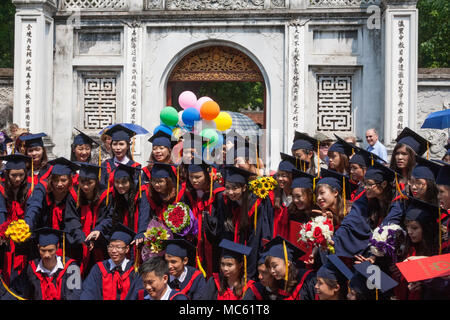 Students celebrating their graduation at the entrance to the Temple of Literature, Hanoi, Viet Nam Stock Photo