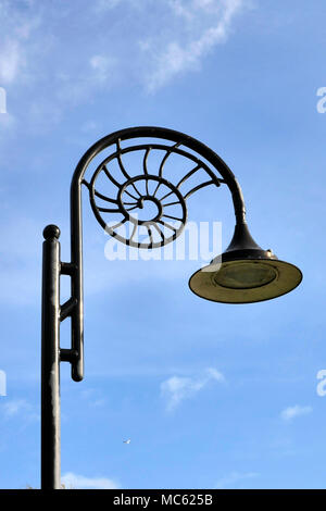 A typical street light in Lyme Regis with the characteristic ammonite design. Stock Photo