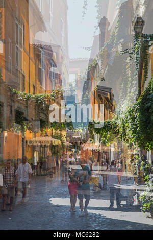 Abstract multiple exposure photo of people walking along a cobbled street in Rome, Italy, past restaurants and bars. Stock Photo