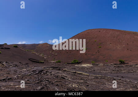 Volcanic hill with a crater seen from the trekking path in Timanfaya National Park on Lanzarote, the Canary Islands, Spain Stock Photo