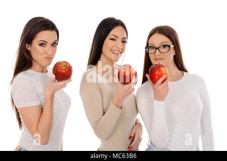 Beautiful group of three girls holding red apples isolated on white background Stock Photo