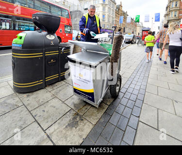London, England, UK. Street sweeper emptying bins in Regent Street Stock Photo