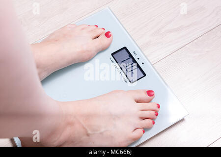 Premium Photo  Women's bare feet on floor scales and measuring tape weight  6070 kilograms