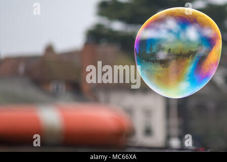 bubble reflecting seaside scene with boat in the foreground and space for caption Stock Photo
