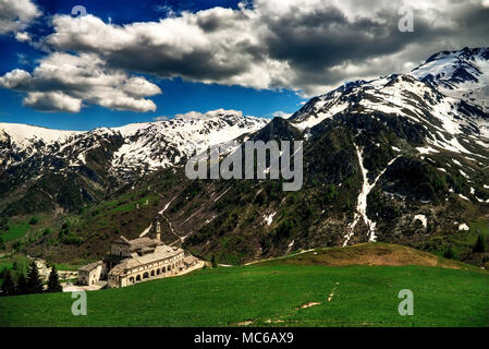 The Catholic sanctuary of San Magno, at 1761 m asl, between the mountains of the upper Grana valley, municipality of Castelmagno, Piedmont, Italy. Stock Photo