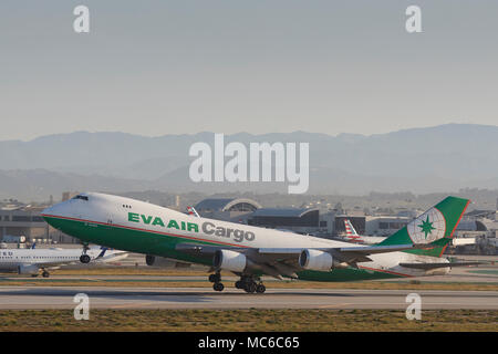 EVA AIR Cargo Boeing 747 Cargo Jet Taking Off From Los Angeles International Airport, LAX. The ATC Control Tower In Background. California, USA. Stock Photo