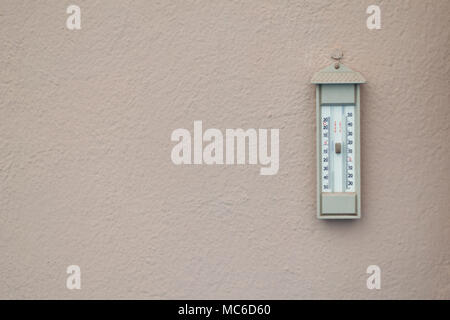 Large round analog thermometer hanging from bracket on outside wall Stock  Photo - Alamy