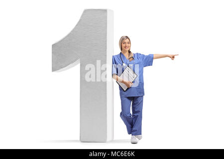 Full length portrait of a female doctor leaning against a number one figure and pointing isolated on white background Stock Photo