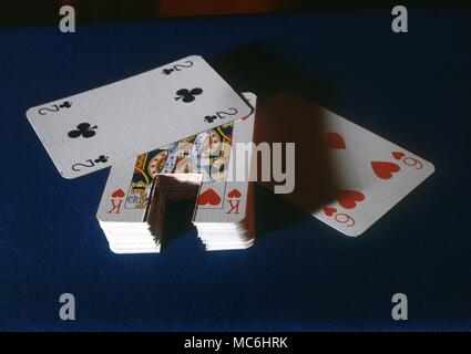 Stage Magic - Card Tricks. The deck of cards has a special area cut out at the bottom. Only the selected card is uncut. This device enables the magician to push the card upwards, either with his finger or with a hidden string. Stock Photo