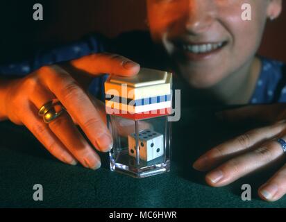 Stage Magic - Appearing dice. A trick involving dice which disappear and reappear ina magic box. Stock Photo