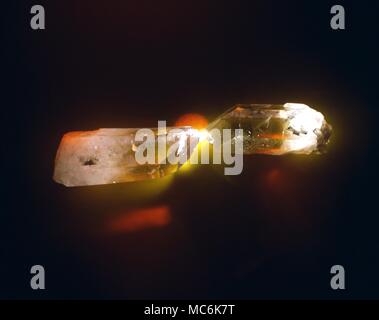 Crystals. Two large quartz crystals, used in healing techniques. Photographed in subdued lighting to reveal the inner form. Stock Photo