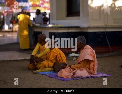 Three Buddhist Monks in the sacred precinct of the Bodhi Tree Sri Lanka Stock Photo