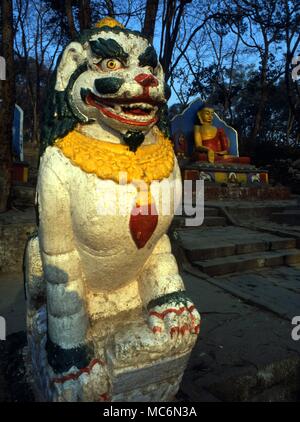 Nepal - Kathmandu Guardian lion among the Buddhist images at the foot of the main stairs leading to the Swayambhunath temple complex. Stock Photo