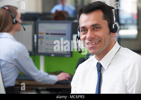 Male Customer Services Agent In Call Centre Stock Photo