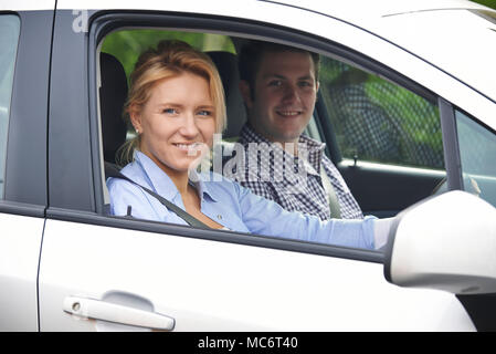 Portrait Of Young Couple Looking Out Of Car Window Stock Photo