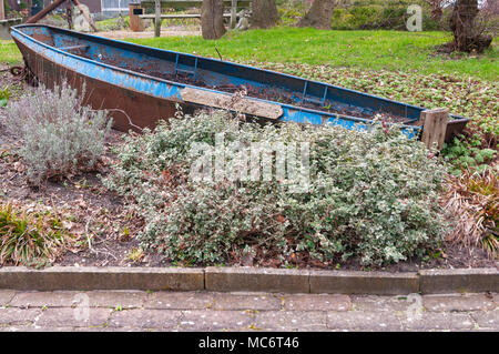 rusted steel row boat placed in a park Stock Photo