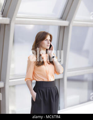 modern business woman talking on smartphone in office Stock Photo