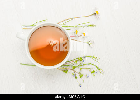 cup of herbal tea on white table Stock Photo