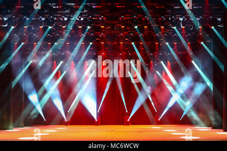 Illuminated empty concert stage with haze and rays of blue and red light. Background for music show Stock Photo