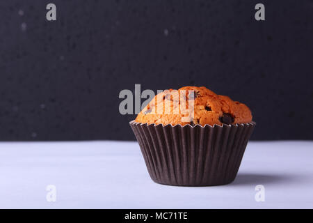 Tasty chocolate cupcakes, muffins on a white wooden table. Stock Photo