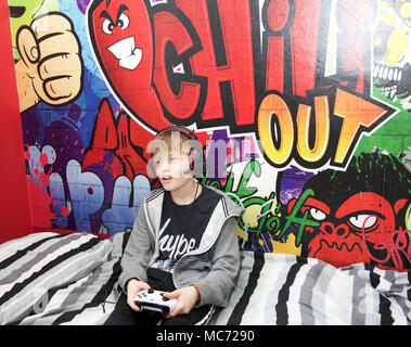 FILE--A young boy plays electronic games on an XBOX ONE game console at a  physical store of Microsoft in Shanghai, China, 26 December 2014. Produc  Stock Photo - Alamy