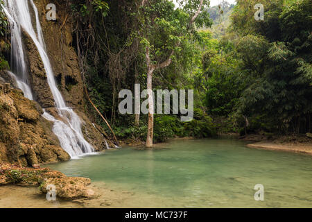 View of idyllic Khoun Moung Keo Waterfall, pond and lush trees near Luang Prabang in Laos. Stock Photo