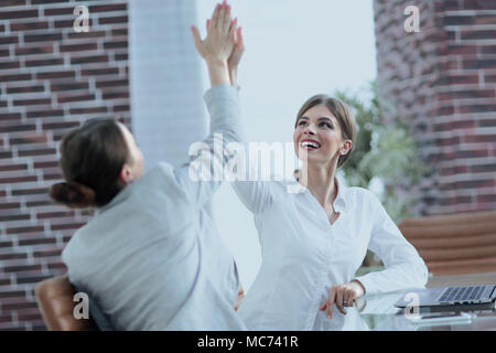 members of the business team happy to the results and giving a high five Stock Photo