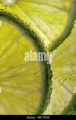 Macro Lime Slices in Sparkling water with bubbles Stock Photo