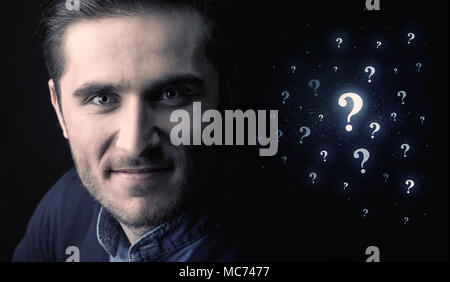 businessman with many question mark near him Stock Photo