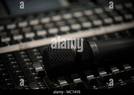 Microphone laying on a mixing desk mixer close Stock Photo