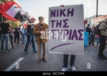 Athens, Greece. 13th Apr, 2018. Protesters holding flags and placards, march towards the American Embassy.Anti-war concentration by various social communities. With slogans such as ''The navy should leave the Aegean and the Mediterranean sea'' and ''Yes to Friendship and Solidarity of People'' after a march, hundreds of protesters arrived outside the US Embassy in Athens. Credit: Vangelis Evangeliou/SOPA Images/ZUMA Wire/Alamy Live News Stock Photo